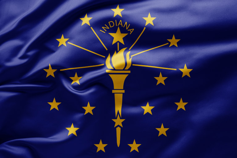 A silk blue Indiana state flag ripples in the breeze.